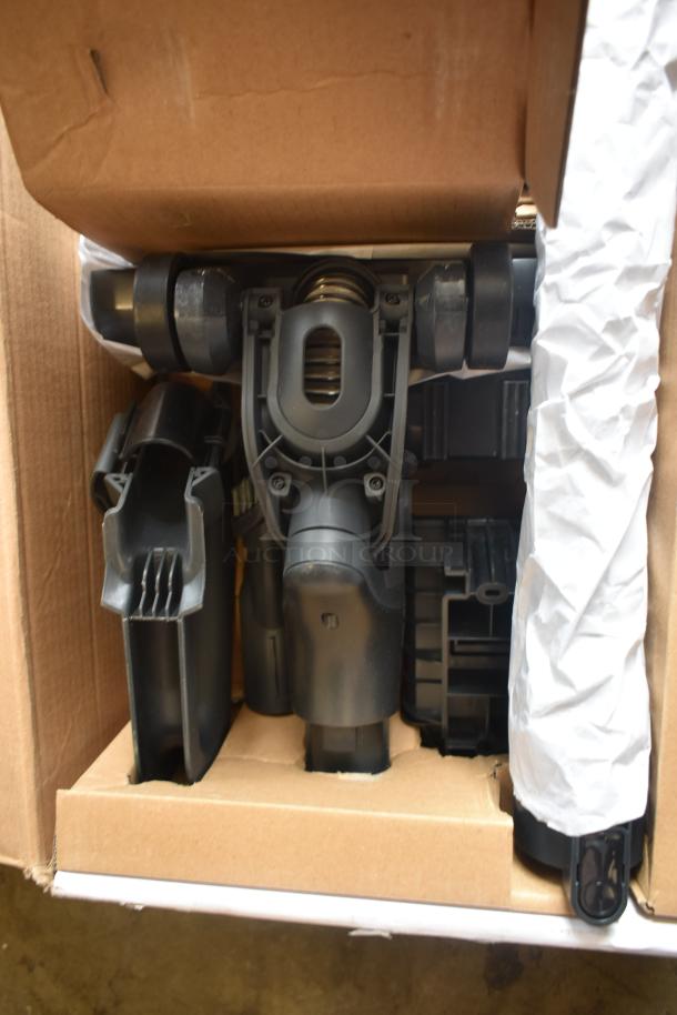 Vacuum cleaner attachment in box, new condition. Includes multiple parts with black plastic components, securely packaged.