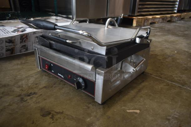 Electric panini press grill, stainless steel, black handle, adjustable temperature dial, "CastIron Pro" label, used condition.