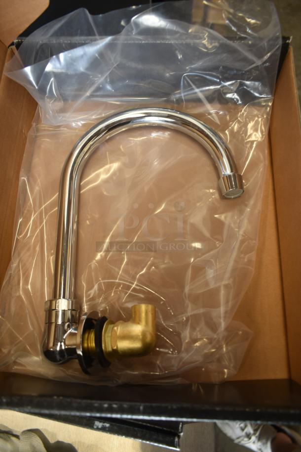 Chrome kitchen faucet in box, new condition, with brass fittings. Packaged in clear plastic within a cardboard box.