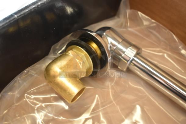 Brass and chrome plumbing elbow connector, new condition, with washer, in clear plastic packaging.