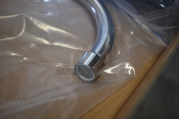 Chrome curved faucet spout, new condition, wrapped in clear plastic. Smooth finish with mesh filter at the end.