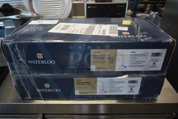Boxed Waterloo electronic hands-free sensor faucet, chrome-plated, wall-mount, new condition, includes installation parts.