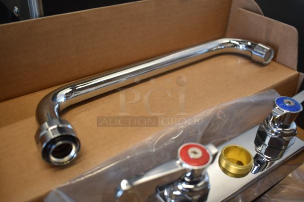 Chrome kitchen faucet set with two levers, red and blue caps, in a cardboard box. Includes a detachable spout, new condition.