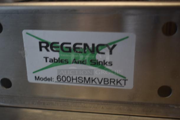 Regency stainless steel furniture part, model 600HSMKVBRKT, labeled for tables and sinks. In good condition.