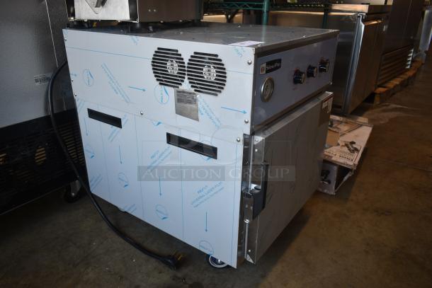 Stainless steel SlowPro commercial oven with dual fans, control knobs, and temperature gauge. New, with protective film intact.