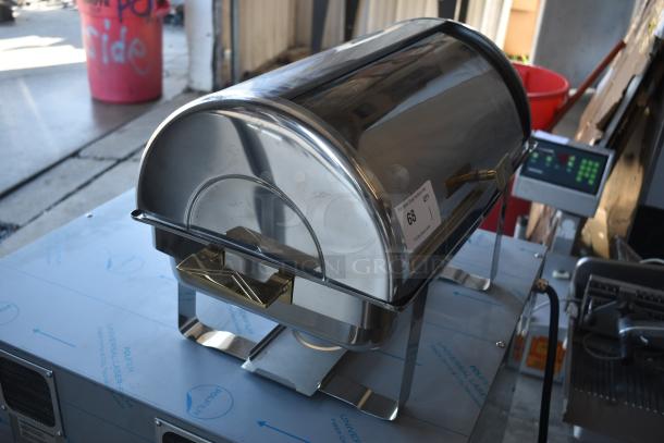 Stainless steel chafing dish with roll-top lid and brass accents, in good condition. Label reads "68, QTY 1."