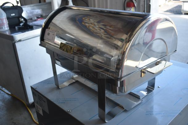Stainless steel roll-top chafing dish with lid, handle, and stand in excellent condition. Auction tag marked "68".