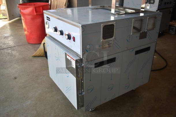Stainless steel industrial oven with control knobs, protective film, and ventilation; new, on wheels, branded ProPro.