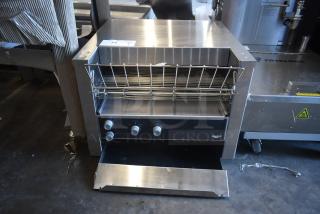 Commercial conveyor toaster with stainless steel finish, three control knobs, and crumb tray. Model: Vollrath. Good condition.