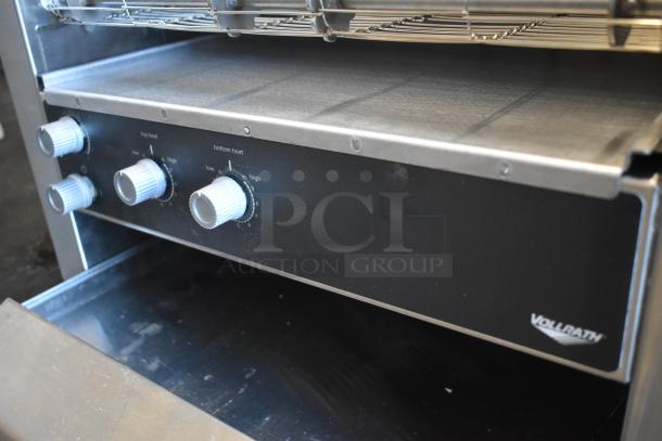 Vollrath conveyor oven with adjustable heat settings, four control knobs, and stainless steel construction. Good condition.