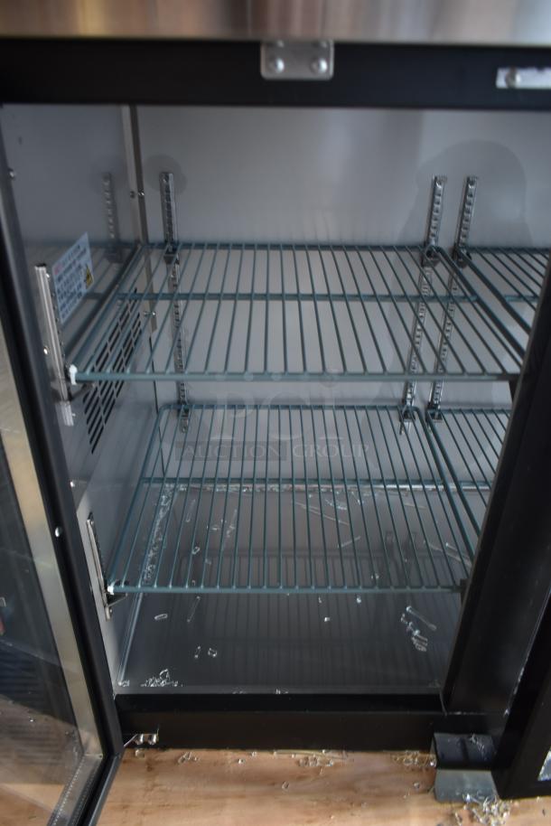 Commercial glass-door refrigerator, two adjustable wire shelves, stainless steel frame, good condition, minor wear.