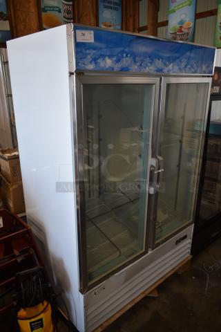 Glass-door commercial refrigerator, brand Avantco, in used condition. Double glass doors with metal handles and a blue top panel design.
