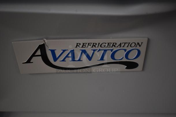 Avantco Refrigeration nameplate on appliance surface, slight wear visible, indicating brand and usage.