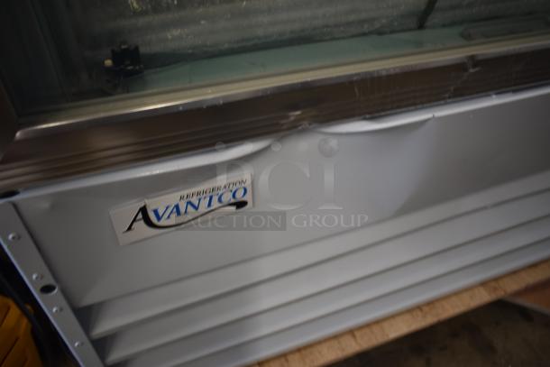 Avantco refrigeration unit with a visible dent on the body, identifiable logo and metallic frame, used condition.