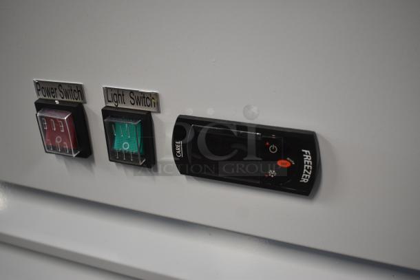 Control panel with labeled power and light switches, plus a Carel freezer control unit in good condition.