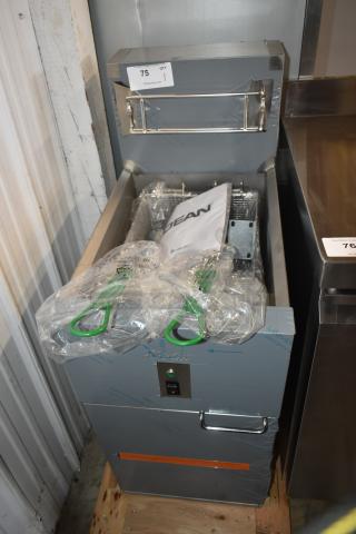 New Dean commercial deep fryer with dual baskets, green handles, protective wrap, and model documentation. Auction lot 75.