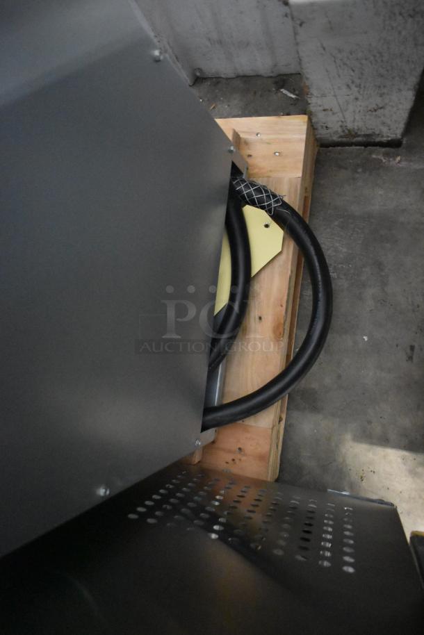 Industrial equipment with metal casing, black cables, and vented panel, in good condition.