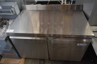 Stainless steel commercial refrigeration unit with Avantco label. Two-door storage, good condition, minor surface marks.