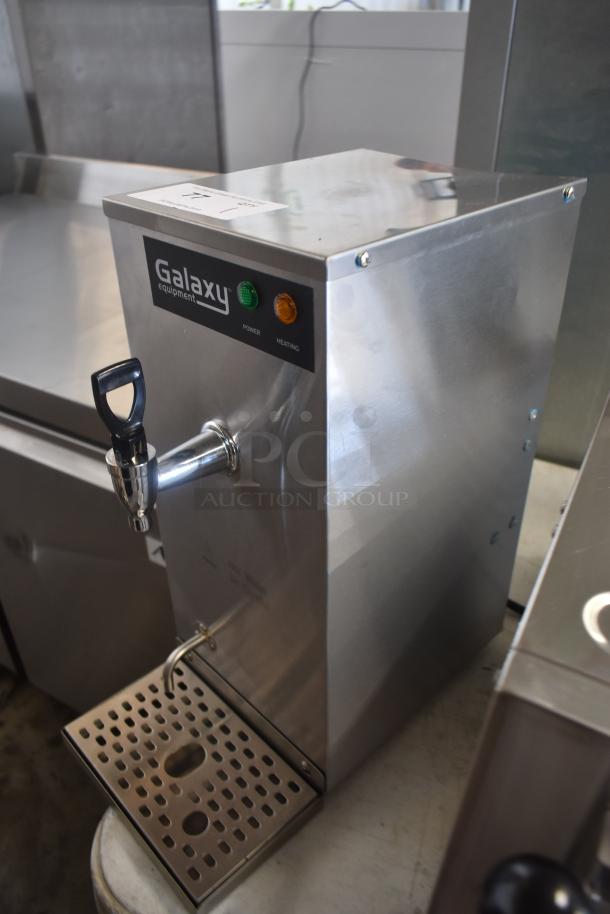Stainless steel Galaxy Equipment hot water dispenser, features tap and drip tray, shows power and heating lights, used condition.