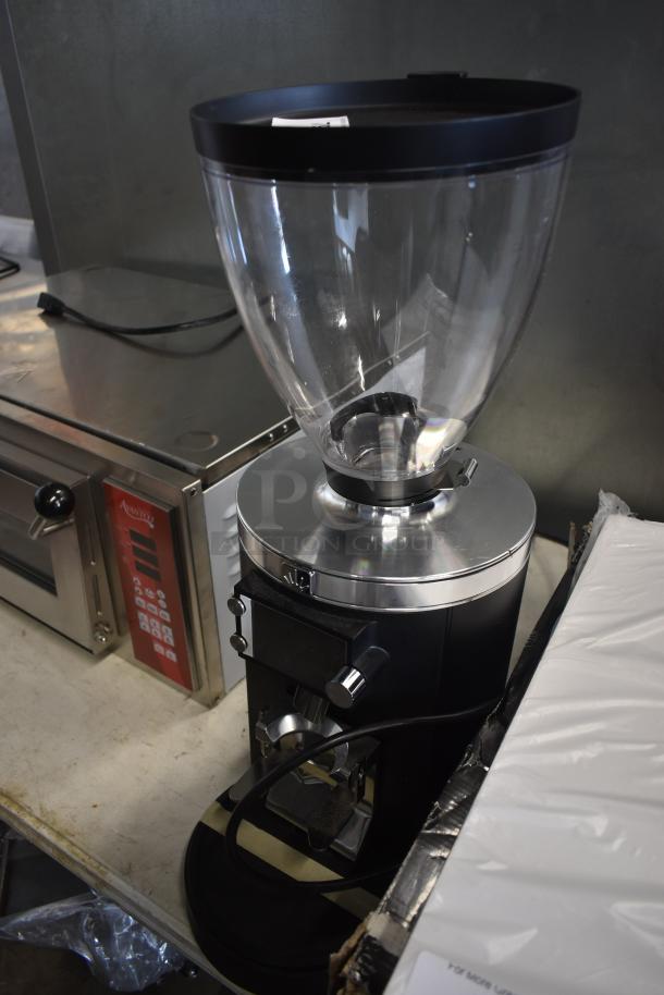 Commercial coffee grinder with clear hopper, black and silver design. Appears in good condition. Ideal for cafes.