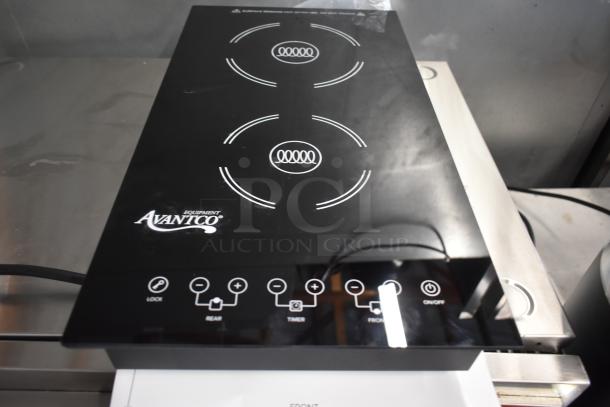 AvantiCo induction cooktop with dual burners, sleek black design, touch controls, minor surface wear, model markings visible.