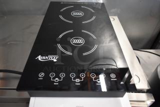 AvantiCo induction cooktop with dual burners, sleek black design, touch controls, minor surface wear, model markings visible.