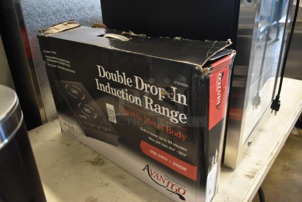 Boxed Avanto Double Drop-In Induction Range, 3100W, durable metal body, black packaging. Box shows wear and tear.