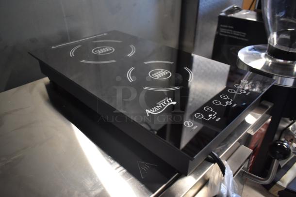 Avantco double induction cooktop, sleek black surface, touch controls, in excellent condition. Ideal for efficient cooking.