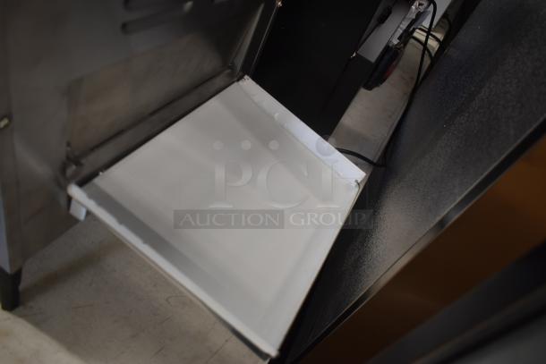 Stainless steel oven door with white insulation, showing minor wear. Suitable for commercial kitchen use. No visible labels.