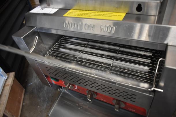 Commercial stainless steel grill with "Caution Hot" warning, featuring adjustable chrome grill and red control knobs, in good condition.