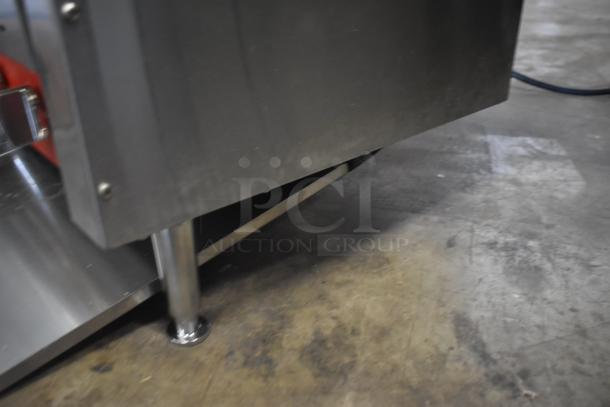 Commercial stainless steel kitchen appliance, sturdy metal legs, clean condition, ideal for industrial use.