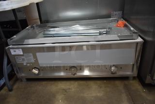 Stainless steel commercial griddle with three control knobs, includes light wear. Labeled Serv-Ware, model and safety info shown.