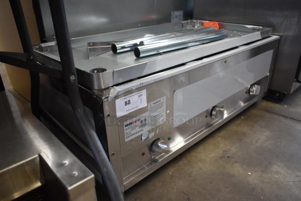 Stainless steel commercial griddle, Serv-Ware brand, temperature control knobs, auction tag number 88, sturdy condition.