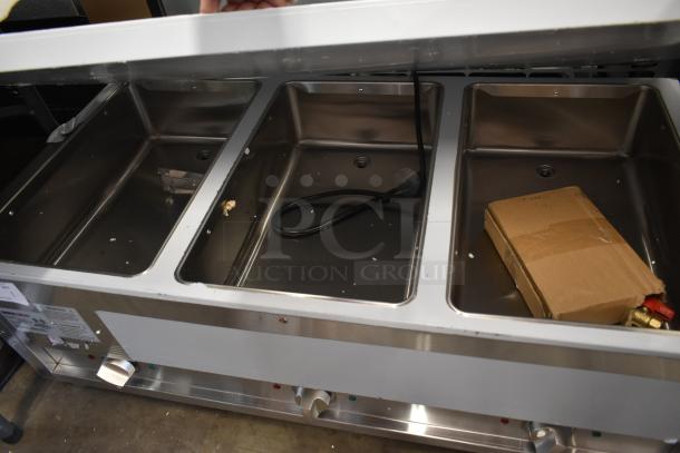 Stainless steel buffet warmer with four compartments, visible power cord, and a cardboard box. Good condition.