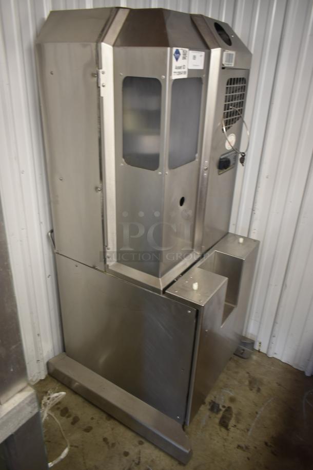 Industrial stainless steel machine with glass panels, labeled "Asset ID: 1775860B," in used condition.