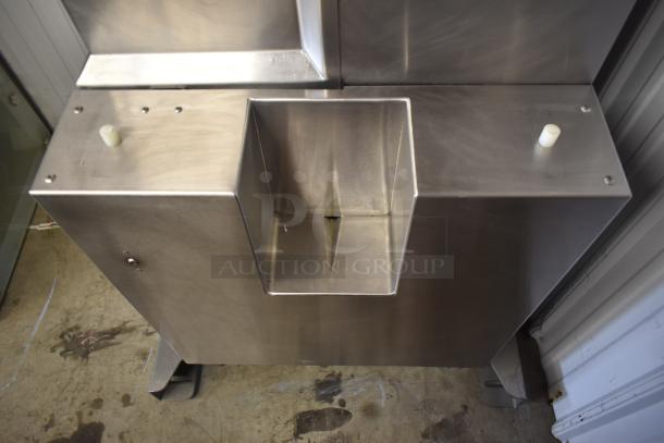Stainless steel commercial sink with dual drain slots, in excellent condition, ideal for industrial use.