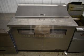 Stainless steel commercial sandwich prep table with dual doors, Superior label, handle on top; ideal for foodservice use.