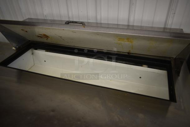 Commercial stainless steel ice chest, lid open, showing interior stains and wear. Ideal for restaurant use; signs of heavy use.