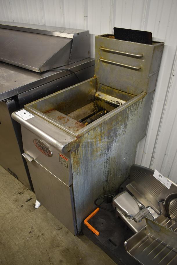 Commercial fryer for auction, stainless steel with visible rust and wear. Model number partially visible, used condition.