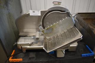 Blakeslee commercial meat slicer with stainless steel blade, visible wear. Markings include "Blakeslee" logo and auction tag "95".