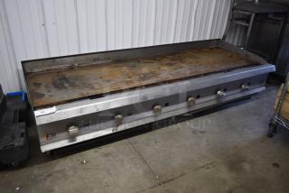 Large commercial griddle with six knobs, weathered condition, CPG brand logo, rust on cooking surface, auction lot tag visible.