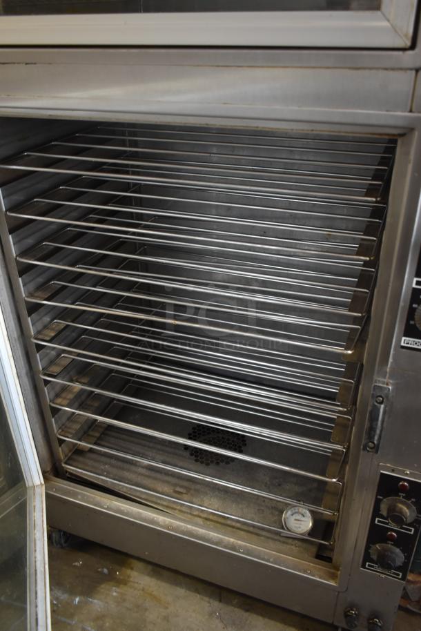 Commercial convection oven with multiple racks, stainless steel, visible temperature gauge, control knobs on side, used condition.