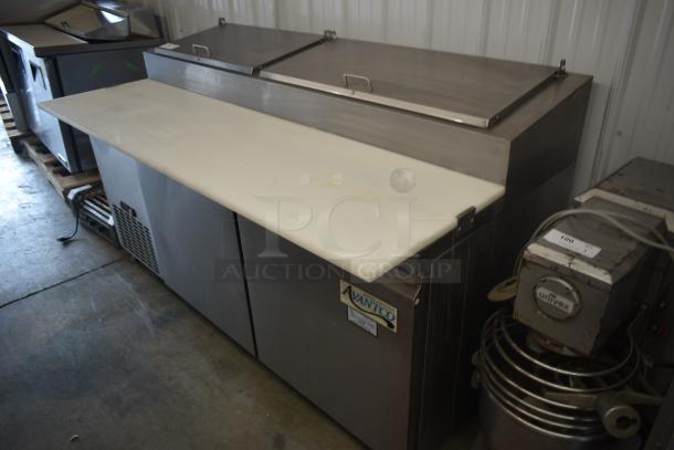 Avantco refrigerated prep table with stainless steel lids, white cutting board, and visible temperature control. Good condition.