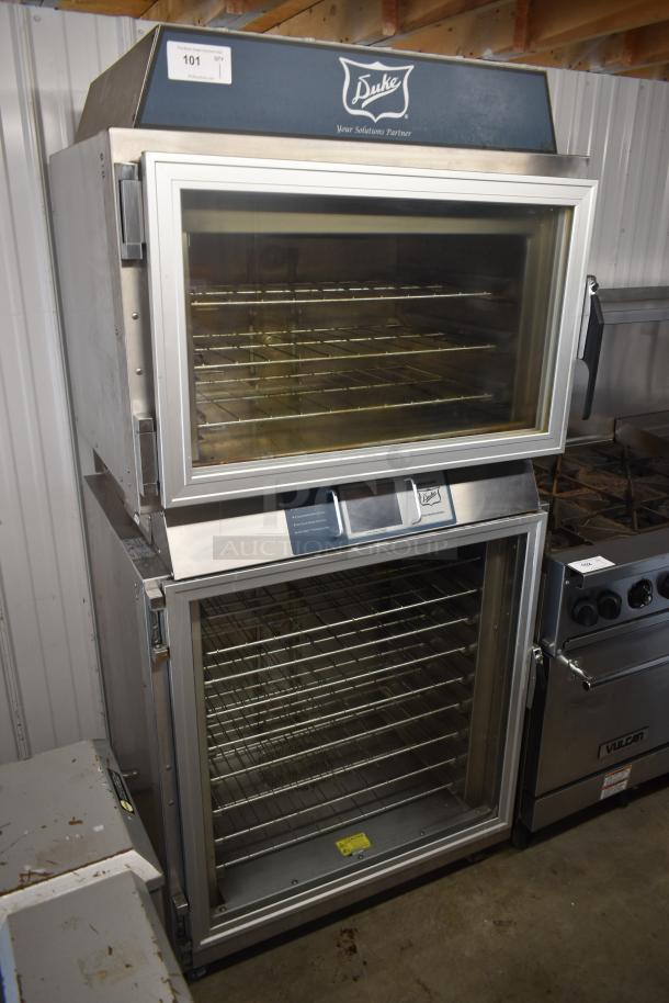 Duke stainless steel commercial oven with multiple racks, transparent doors; excellent condition, auction tag visible.
