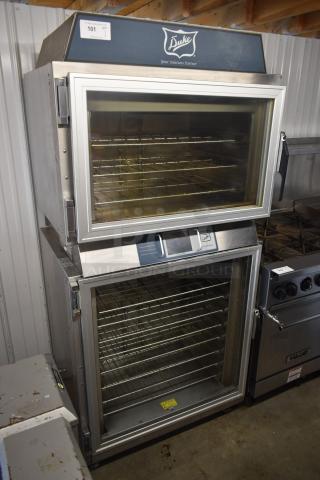 Duke stainless steel commercial oven with multiple racks, transparent doors; excellent condition, auction tag visible.