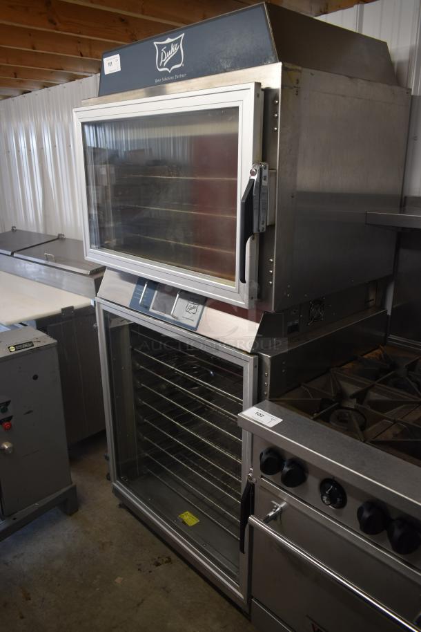 Duke convection oven with dual glass doors, stainless steel construction, multiple racks, in good condition, auction tag visible.