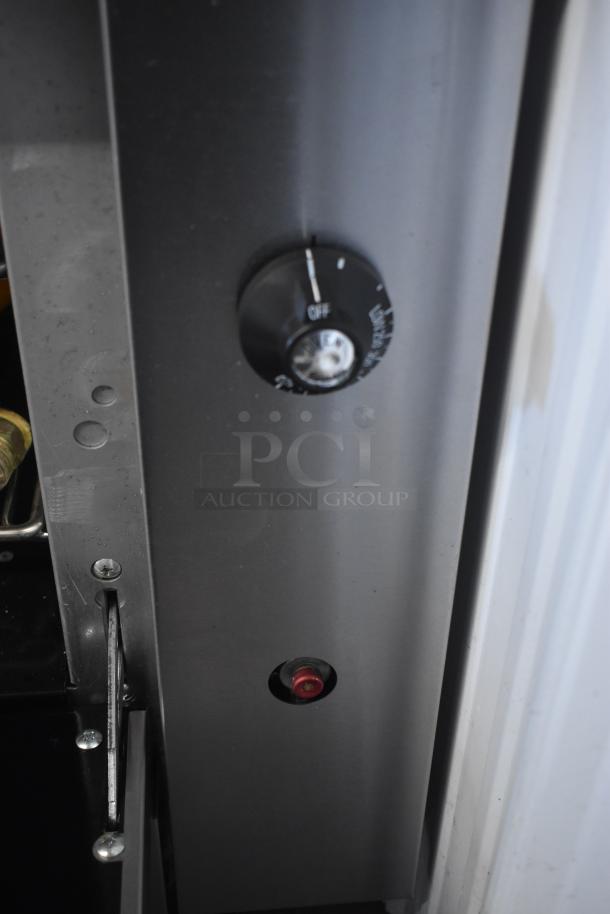 Metal control panel with black dial labeled "OFF" and red indicator light, in good condition.