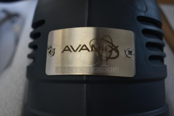 Avamix equipment label on dark appliance, metallic finish, brand logo centered. Appears to be kitchen or industrial equipment.