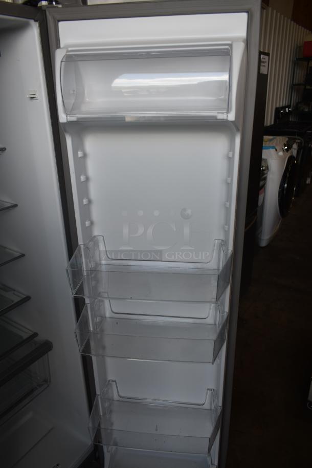 Refrigerator door interior with four clear storage bins in good condition, no visible labels.