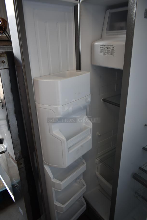 Open refrigerator showing white interior, adjustable shelves, and door storage. Slight wear visible. No brand markings.